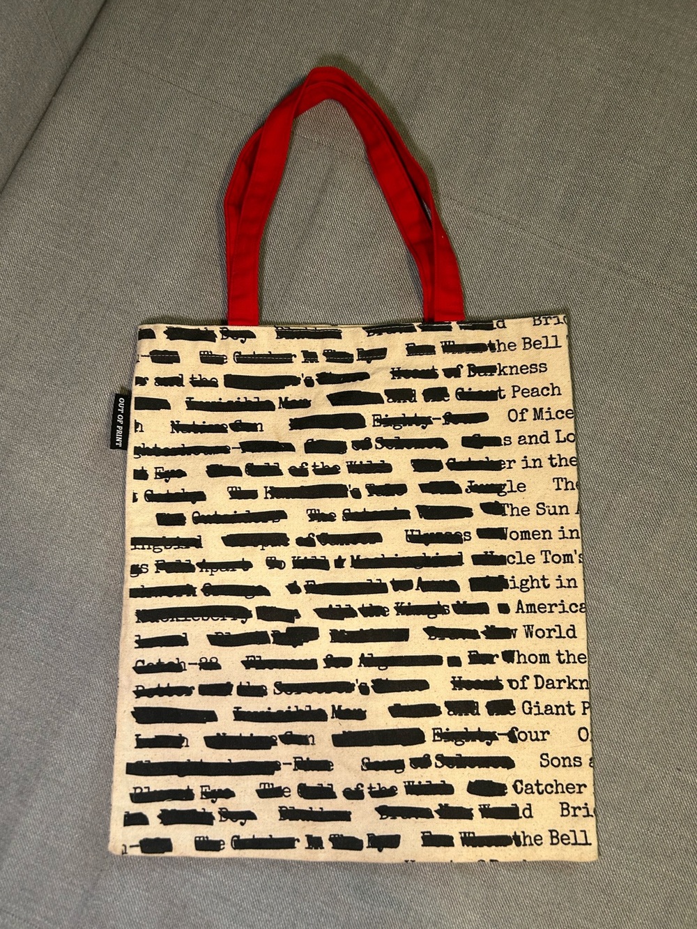 Out of Print Black Text Canvas Tote with Red Handles
